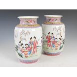 A pair of Chinese porcelain famille rose vases, Republican Period, decorated with scene of ladies in
