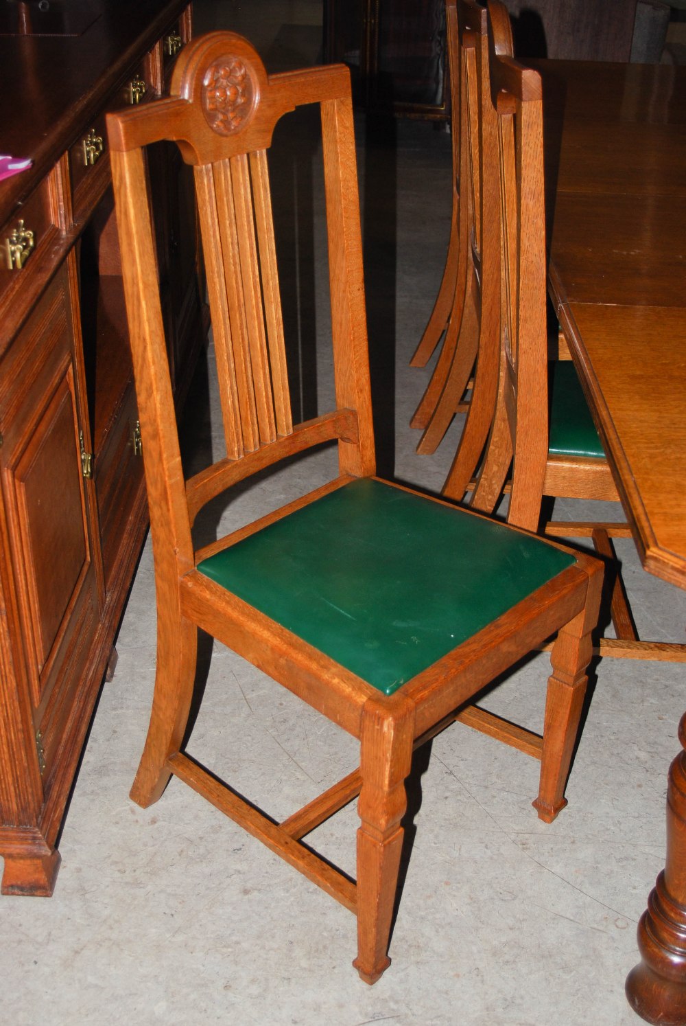 A late 19th century oak dining room room suite, comprising; an extending dining table enclosing four - Image 8 of 9