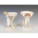 A pair of 19th century Royal Worcester figural comports modelled by Hadley, dated 1884, modelled