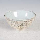 A Chinese white metal mounted celadon glazed porcelain bowl, the white metal mount pierced with