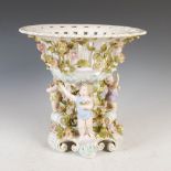 A late 19th/early 20th century Continental porcelain table centrepiece, the flower encrusted
