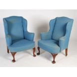 A pair of early 20th century mahogany wing armchairs, the blue upholstered backs, arms and seats