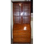 A 19th century mahogany bureau bookcase, the moulded cornice above two astragal glazed cupboard