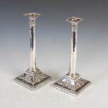 A pair of George III silver Corinthian column silver table candlesticks, London, 1771, makers mark
