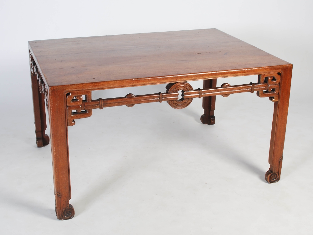 A Chinese huanghuali writing table, Qing Dynasty, the rectangular top above a pierced and scroll