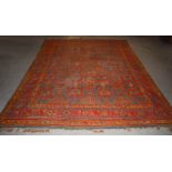An Ushak carpet, late 19th/ early 20th century, the blue/ green ground decorated with rows of orange