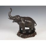 A Japanese bronze figure of an elephant, Meiji Period, signed, on carved wood stand, 22cm high x