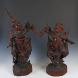 A pair of late 19th/early 20th century carved wood Burmese dancing figures, 69cm high and 55cm