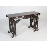 A Chinese dark wood table, late 19th/early 20th century, the rectangular panelled top above a