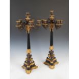 A pair of late 19th century Regency style bronze, ormolu and polished black stone six light