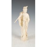 A Chinese ivory figure of a lady, Qing Dynasty, carved standing wearing long flowing robes,