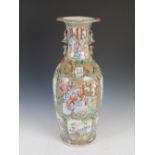 A large Chinese porcelain famille rose Canton vase, Qing Dynasty, decorated with shaped panels of