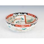 A Japanese Imari porcelain bowl, early 20th century, the interior decorated with two red capped