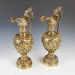A pair of late 19th century Continental Renaissance Revival gilt metal ewers, cast with putti and