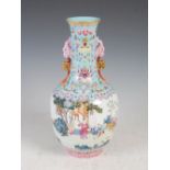A Chinese porcelain famille rose bottle vase, Qianlong mark but later, decorated with continuous
