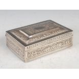 A late 19th century Indian silver rectangular box, embossed with panels of buildings and trees, 16cm