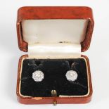 A pair of mid 20th century white metal diamond cluster earrings, each centred with a round brilliant