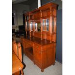 A late 19th century oak dining room room suite, comprising; an extending dining table enclosing four