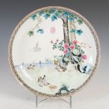 A Chinese porcelain famille rose dish, Republican Period, decorated with doves in a fenced garden of