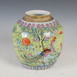 A Chinese porcelain green ground famille rose jar, Qing Dynasty, decorated with a pair of phoenix,