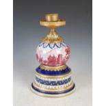 A gilt metal mounted Sevres style porcelain lamp base, with puce decoration of figures in a wooded