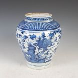 A Japanese blue and white Arita porcelain jar, Edo Period, decorated with rock work issuing