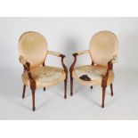 A pair of 19th century George III style mahogany elbow chairs, the satin upholstered oval backs,