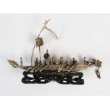 A late 19th/ early 20th century Chinese silver dragon boat, on carved and pierced wood stand, 15cm