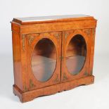 A 19th century walnut, boxwood lined and ormolu mounted side cabinet, the rectangular top above a