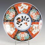 A Japanese Imari dish, late 19th/early 20th century, centred with a circular roundel enclosing