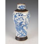 A Chinese blue and white porcelain crackle glazed jar, Qing Dynasty, decorated with two peacocks and