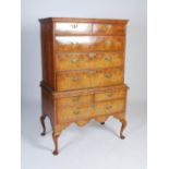 An 18th century walnut chest on stand, the rectangular top with a moulded edge over two short and