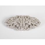 An Art Deco white metal diamond set double clip brooch, set with a line of four old cut diamonds,