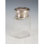 A Continental white metal mounted clear glass dressing table bottle, stopper and cover, the lift off