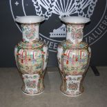 A pair of Chinese porcelain famille rose floor vases, 20th century, decorated with panels of figures