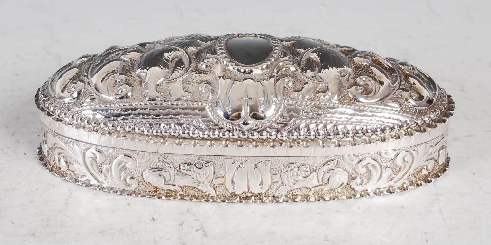 A Victorian silver oval shaped box and cover, Birmingham, 1891, makers mark of H&A, with embossed