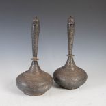 A pair of late 19th century Middle Eastern white metal bottle vases and covers, chased with