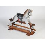 A late 19th/early 20th century rocking horse, the horse with later painted detail, later bridle