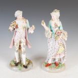 A pair of late 19th century Dresden porcelain figure groups, modelled as male and female figures