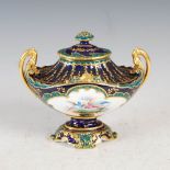 A Royal Crown Derby cobalt blue ground twin handled urn and cover, decorated by E. Clark, dated