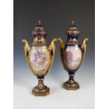 A pair of late 19th century Sevres porcelain cobalt blue ground ormolu mounted twin handled urns and