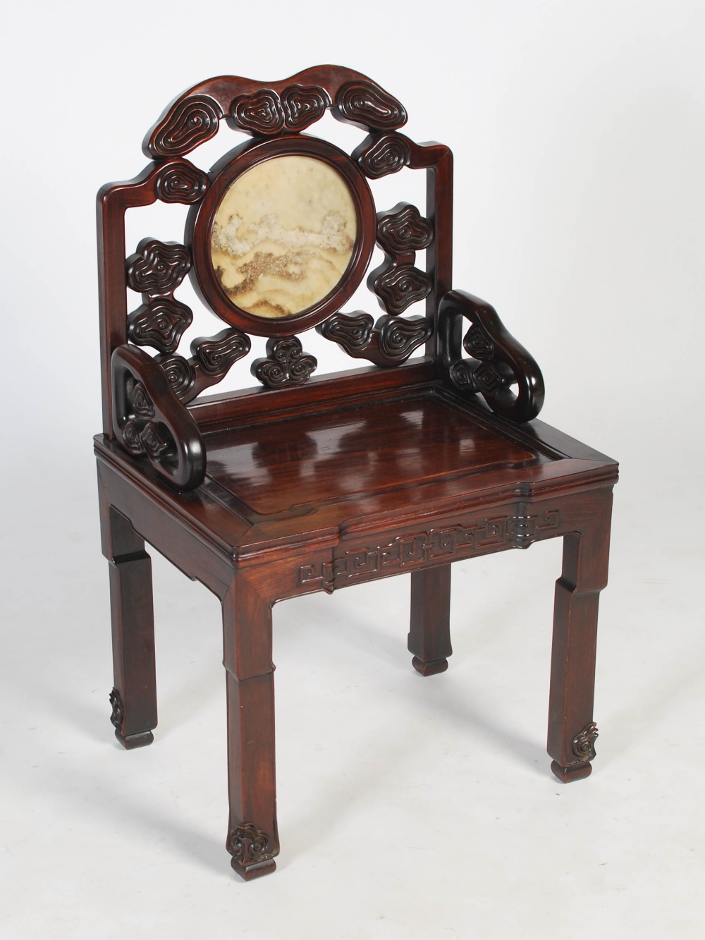 A Chinese hongmu chair, Qing Dynasty, early 19th century, the scroll carved back centred with a