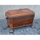 An early 19th century mahogany sarcophagus shaped wine cooler, the hinged rectangular cover with