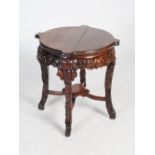 A Chinese dark wood fish bowl stand, Qing Dynasty, the shaped circular top above a foliate carved