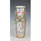 A Chinese porcelain famille rose Canton vase, Qing Dynasty, decorated with panels of figures divided
