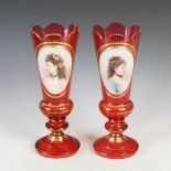A pair of late 19th century Bohemian ruby glass vases, overlaid with opaque white oval panels