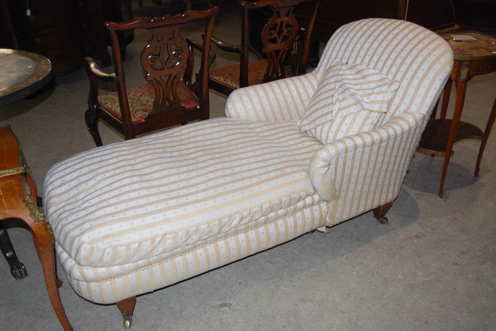 A late 19th/ early 20th century mahogany day bed/ chaise lounge in the style of Howard & Sons, the