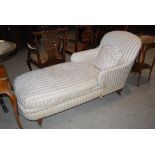 A late 19th/ early 20th century mahogany day bed/ chaise lounge in the style of Howard & Sons, the