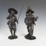 A pair of Japanese bronze figure groups, Meiji Period, modelled as male farm worker and female