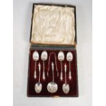 A cased set of six Victorian silver teaspoons, tongs and sifting spoon, Sheffield 1898, makers